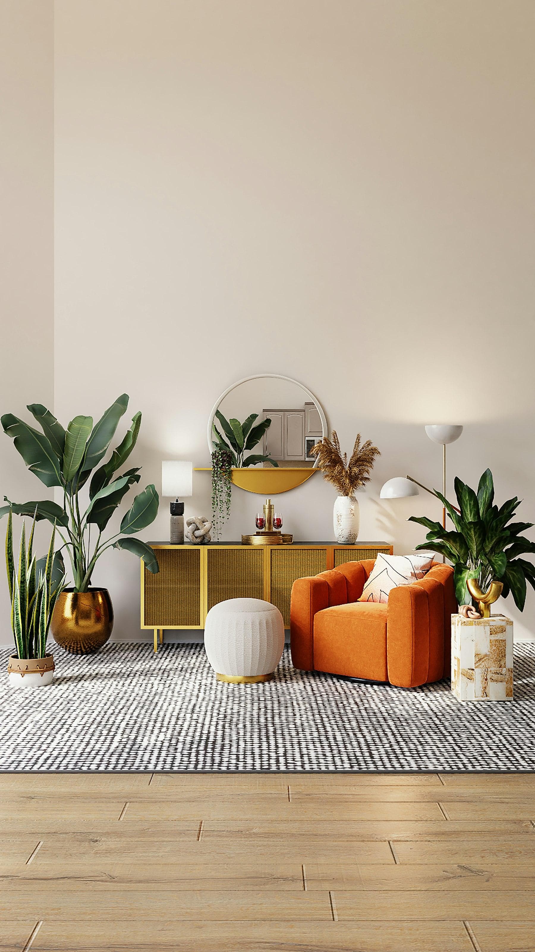 Styled corner with an orange armchair, plants and a round mirror