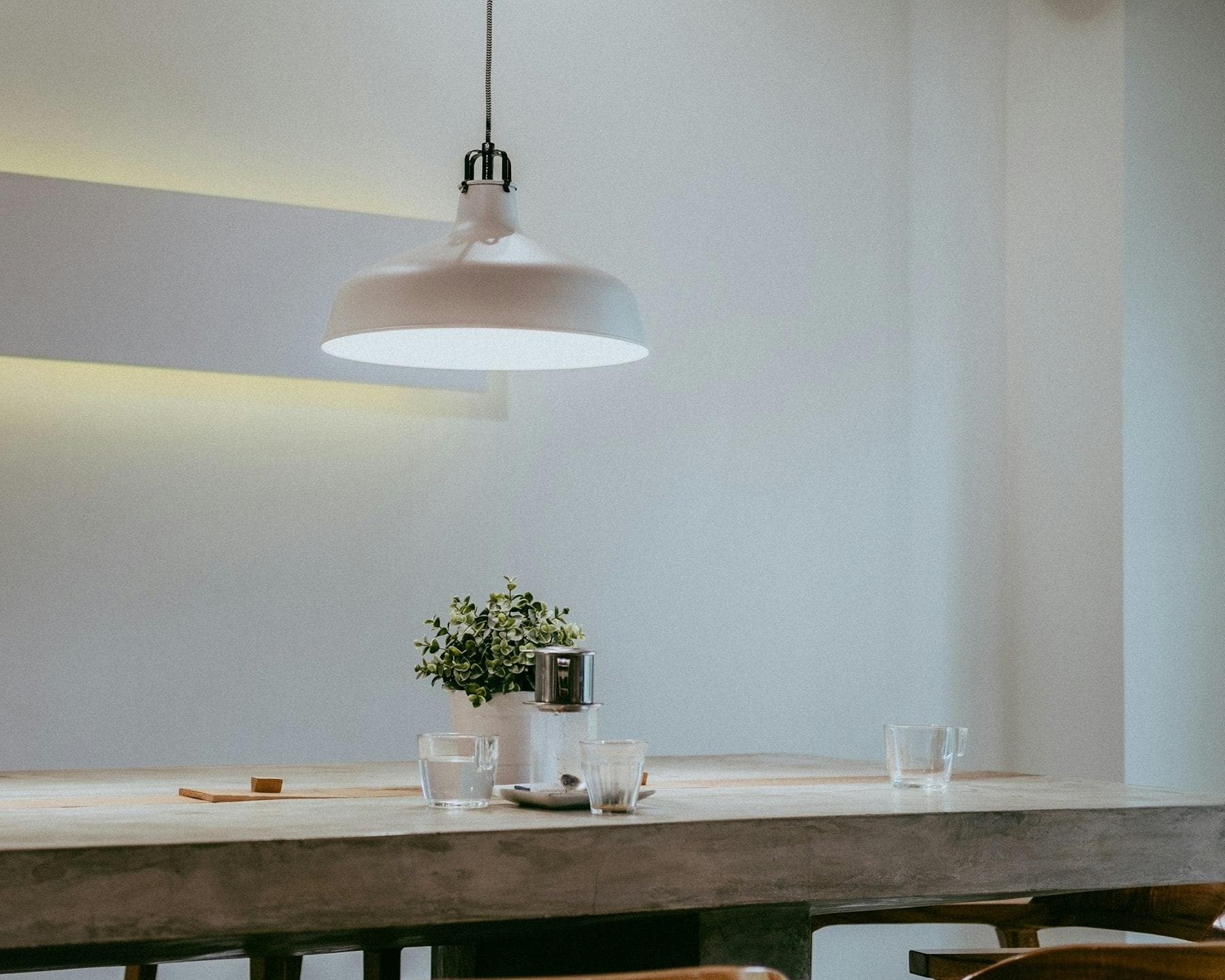 White pendant light above a dining table