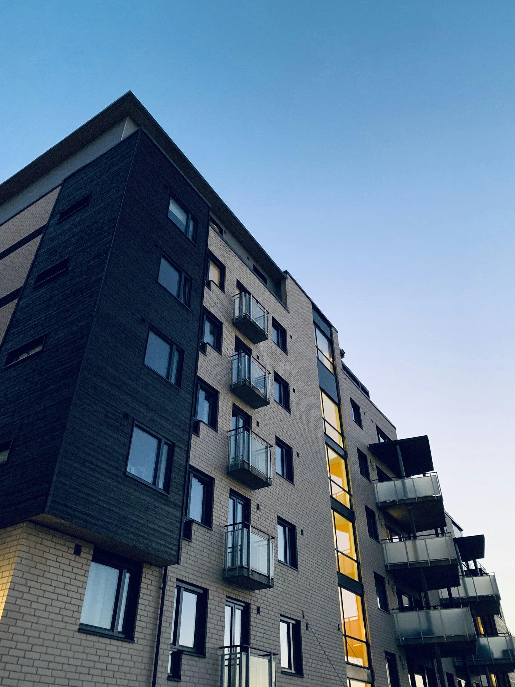 Apartment building with balconies against a blue sky