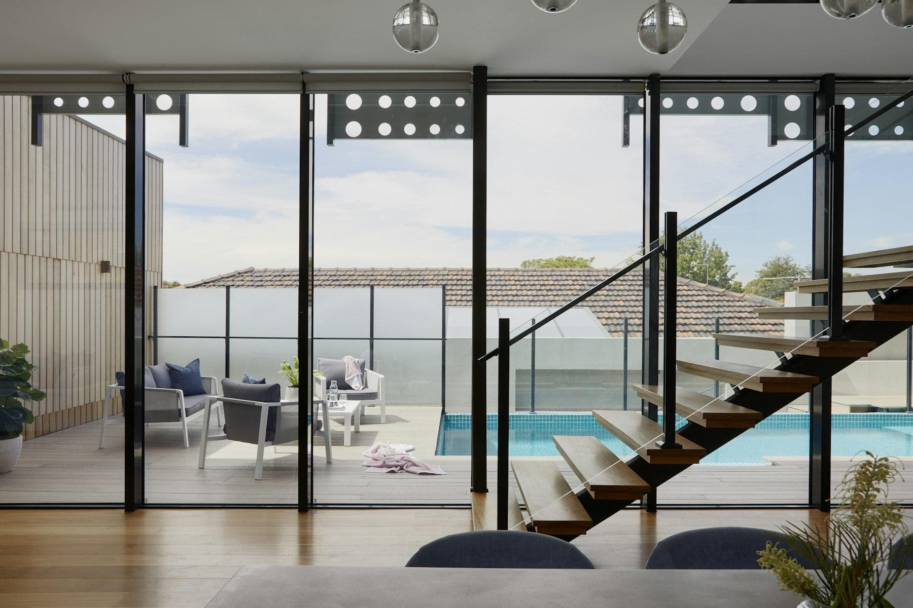 A single still photo of a living room with a staircase